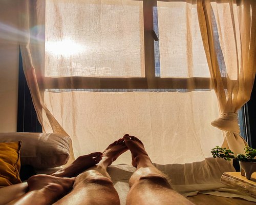 person stretching gently at home with morning sunlight